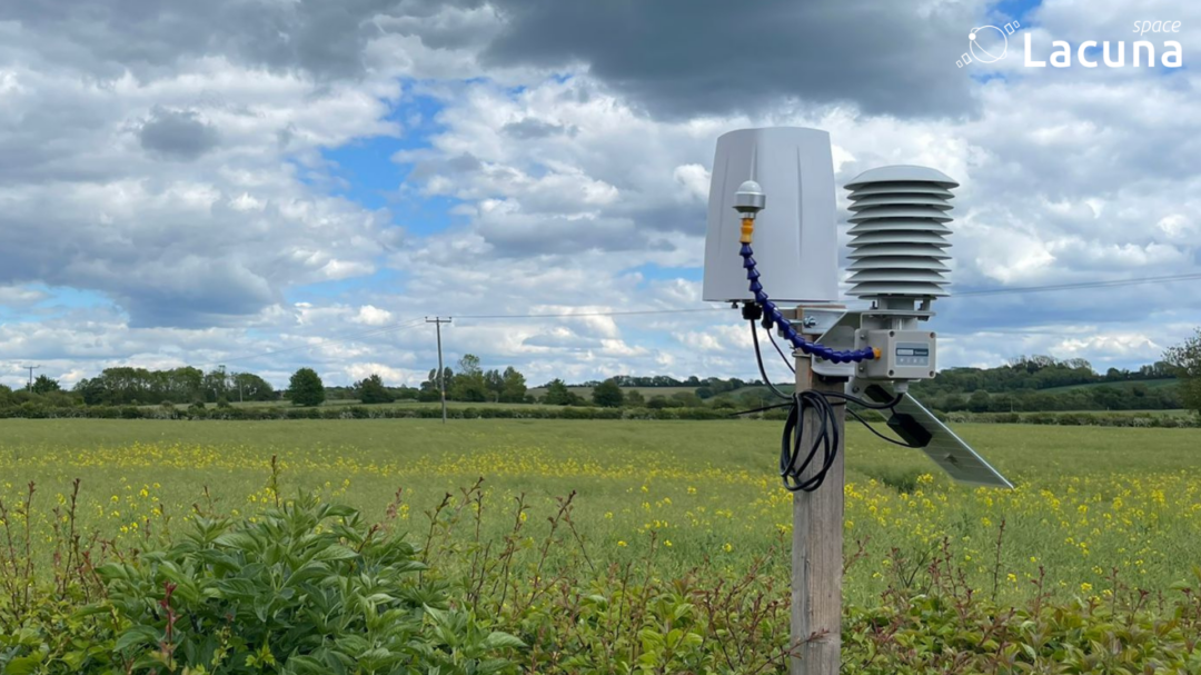 Weather station in a remote field with Lacuna space logo on it