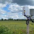 Weather station in a remote field with Lacuna space logo on it